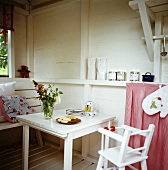 Table with child's tableware, biscuits and high chair