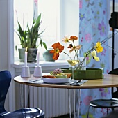 Place-setting with salad and a glass of wine, candles