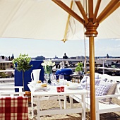 Laid table with sunshade on a balcony