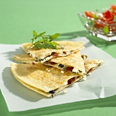 Quesadilla filled with olives, dried tomatoes, feta