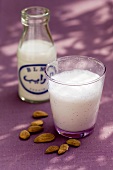 Milk bottle and a glass of almond milk with rose water