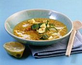 A plate of lentil & coconut soup with courgette & curry powder