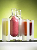 Various smoothies in glasses and glass bottles