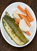 Pickled cucumbers, carrots and radish on a platter