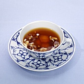 A cup of East Frisian tea with cream and sugar crystals