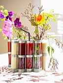 Various smoothies in test tubes with floral decoration