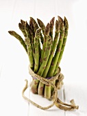 A bundle of green asparagus tied with string