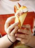 Strawberry ice cream with lemon curd in wafer cone