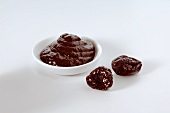 Powidl (Plum jam) in a small dish and dried plums
