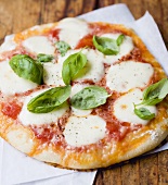 Mozzarella and tomato pizza with basil