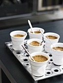 Coffee cream in six beakers