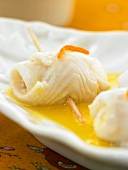 Lemon sole rolls in orange sauce