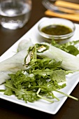 Chicken spring roll on herb salad with herb sauce