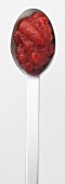 Raspberry and strawberry puree on a spoon