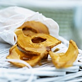 Caramelised apple rings, partly in a bag