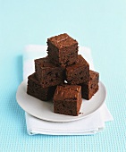 A stack of chocolate brownies on a plate