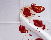 Blobs of ketchup on tablecloth