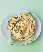 Seafood gratin with Parmeasn in a shell