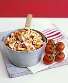 Macaroni with tomatoes and shrimps in a pan