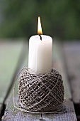 Burning candle in a ball of string