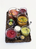 Assorted fruit compotes in glasses on a tray