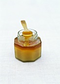 Ein Glas Honig mit Löffel