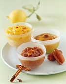 Three different mango chutneys in small glass bowls