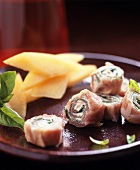 Ham and soft cheese rolls with basil and melon