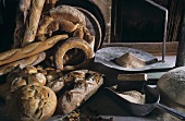 Various types of bread, flour and utensils