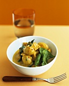 Sea bream and mushroom curry with spinach leaves