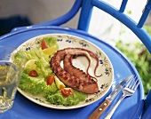 Octopus with lettuce, tomato and lemon wedges