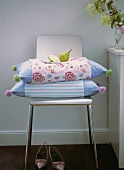 Coloured pillows with a pear on chair