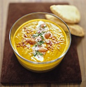 Pumpkin soup with sour cream, paprika and pita rolls