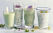 Four glasses of yoghurt milk drink with herbs
