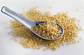 Porcelain spoon with brown long-grain rice