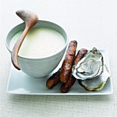 Oyster soup with sausages and fresh oysters