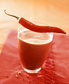 A glass of hot chocolate with chili