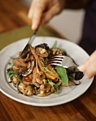 Leaf salad with mushrooms, potatoes and fried veal