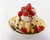 Semolina pudding with whipped cream, raspberries and grated chocolate