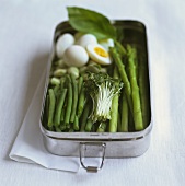 Lunch box with vegetables an quails eggs