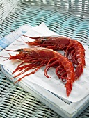 Two Palamos prawns on a piece of paper in a basket
