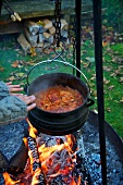 Rice stew hanging over a camp fire