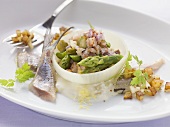 Soused herring tatar with asparagus in an onion ring with a horseradish and apple sauce