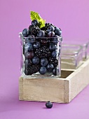 Blueberries and blackberries in a glass bowl