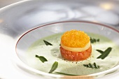 Wild herb soup with a layered canape made with potato, white fish tartar and caviar