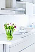 A bunch of tulips in a white kitchen