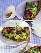 Leeks, tomatoes and pumpkin seeds on toasted bread