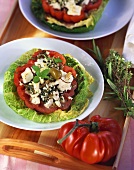 Tomato stuffed with feta cheese & olives on savoy cabbage leaf
