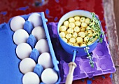 Semolina dumpling soup, white eggs in egg box beside it