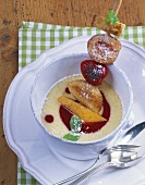 Fruit skewer on semolina pudding with raspberry sauce